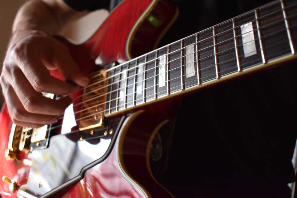 Photo of Hunter playing a guitar